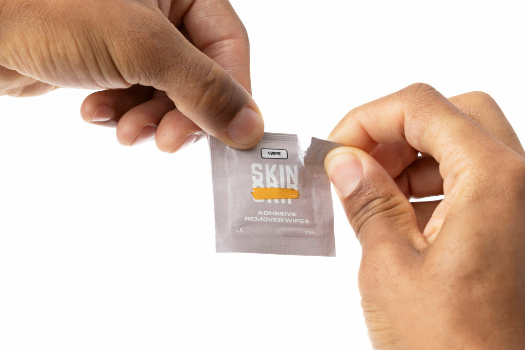 Using a Skin Grip remover wipe to lift a CGM patch